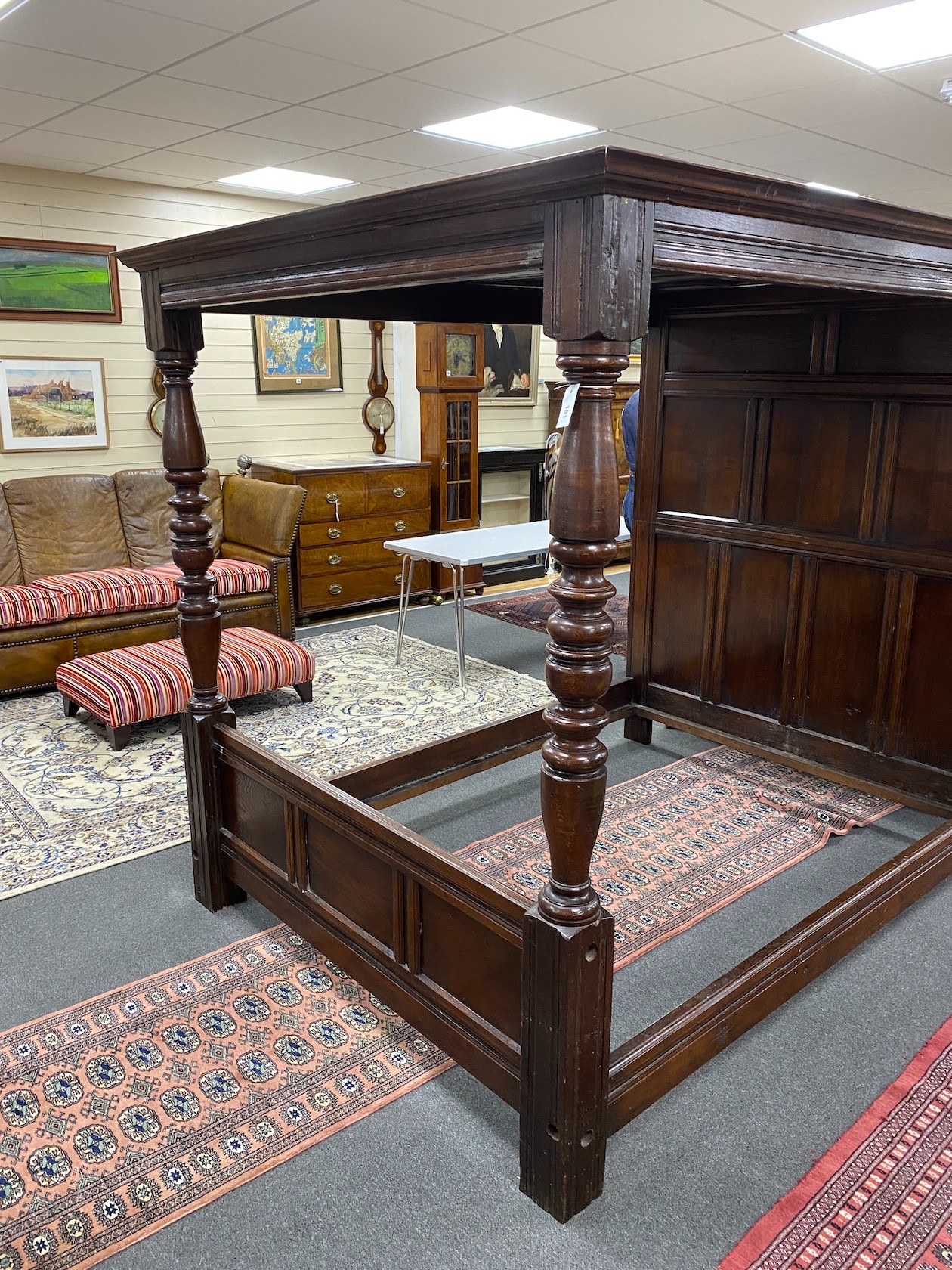 An 18th century style oak four poster bed with panelled canopy, width 162cm, length 221cm, height 194cm